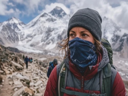 Trekker wearing buff to warm and humidify cold dry air