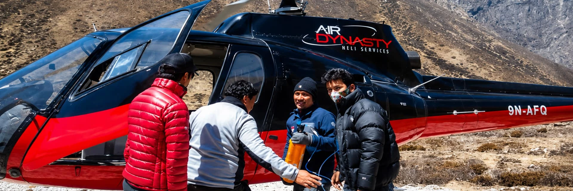 Air rescue team preparing emergency helicopter evacuation with oxygen supply for altitude sickness on Everest trek