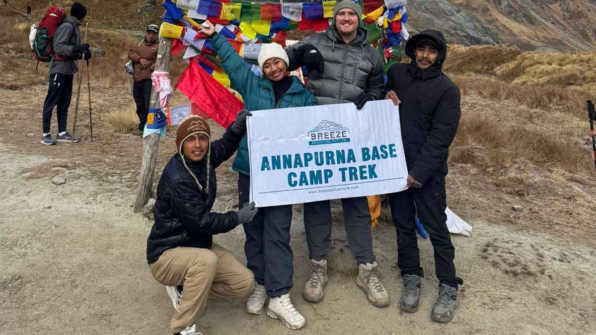 Breeze Adventure team with company banner in ABC Nepal