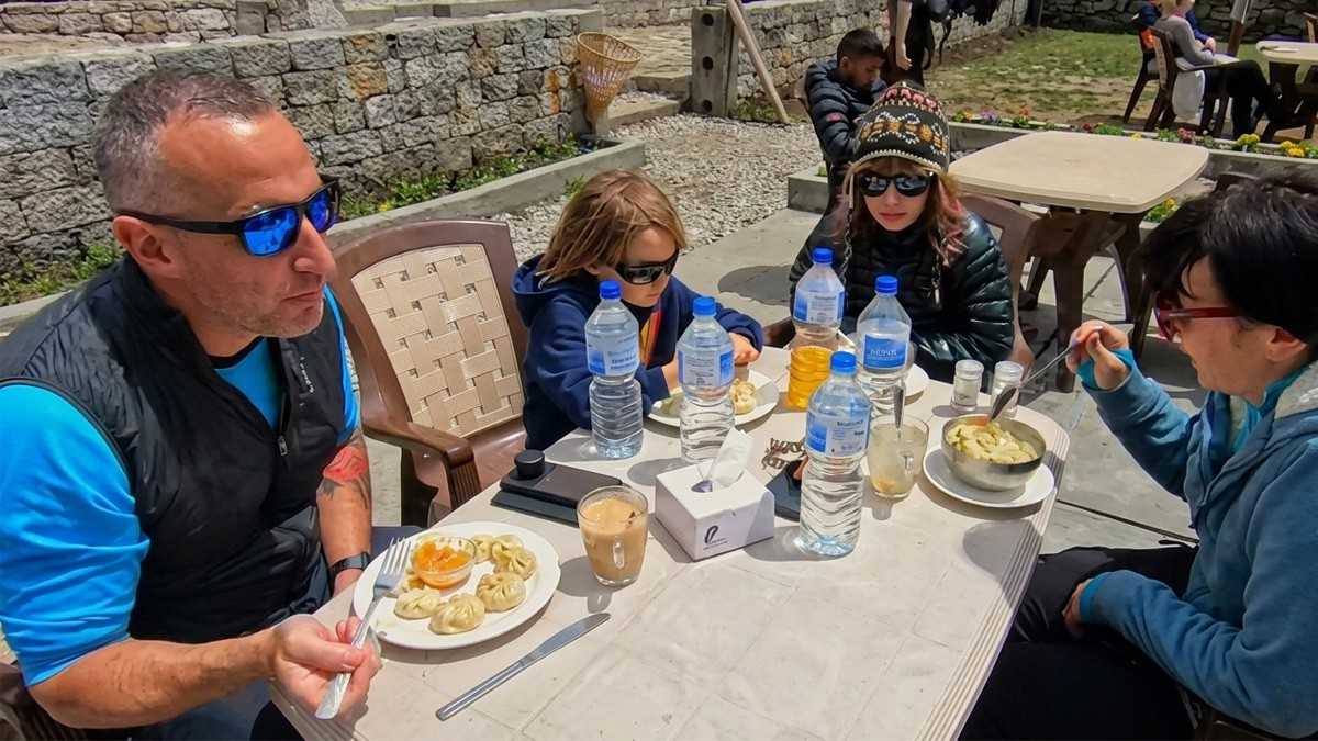 Family enjoying momo and tea with kids in Everest Base Camp Trek 