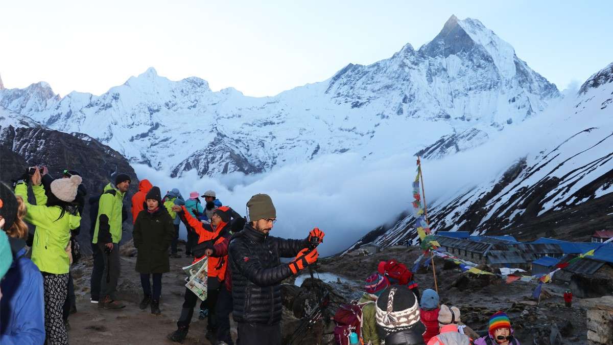 Trekkers taking photographs from Annapurna Base Camp
