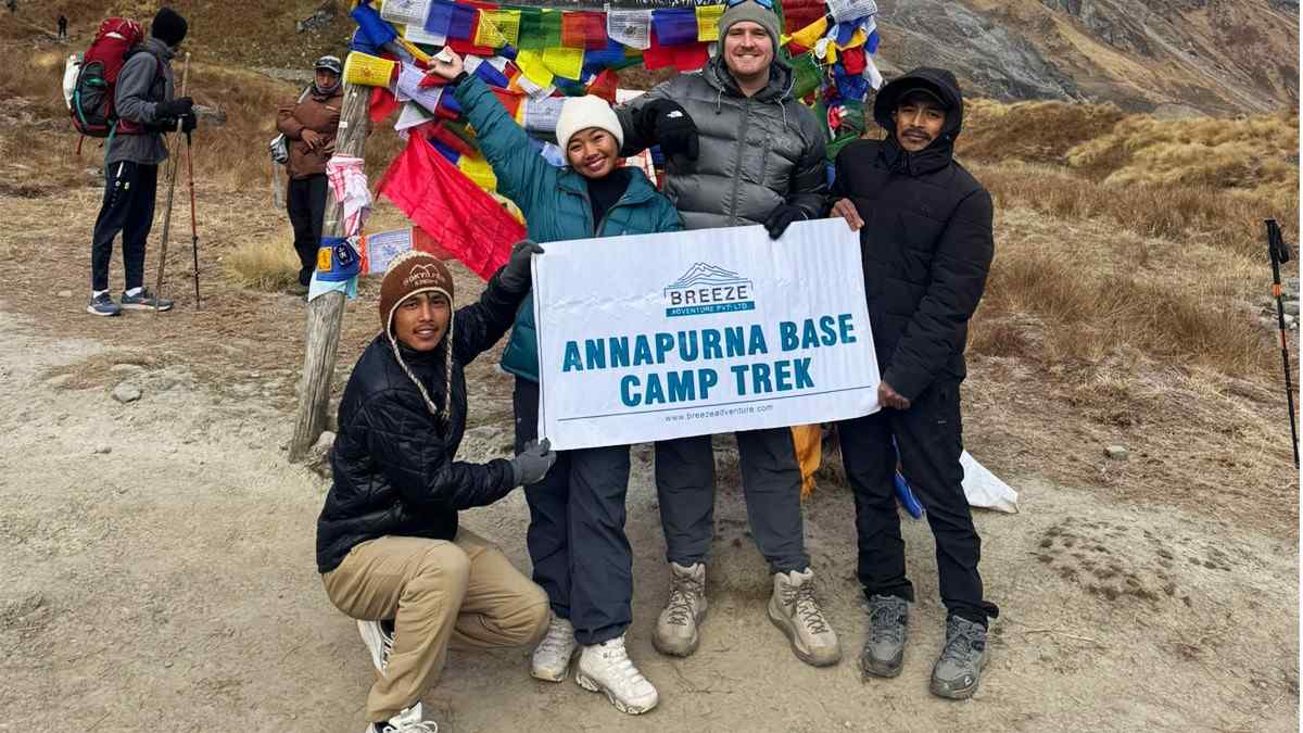 Breeze Adventure Team holding company banner in Annapurna Base Camp