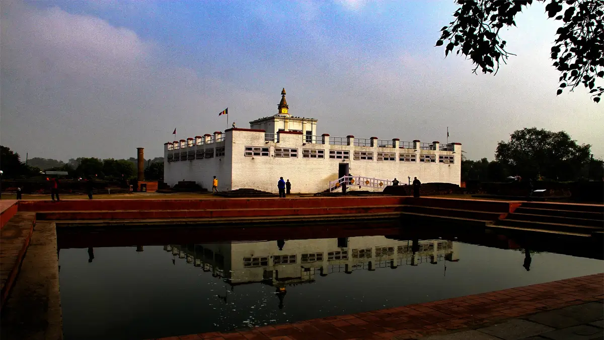 The white Maya Devi Temple reflected in the sacred pond at Lumbini