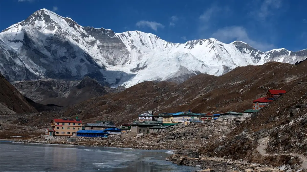 Gokyo Lake teahouses with snow-capped Himalayan peaks in background Nepal