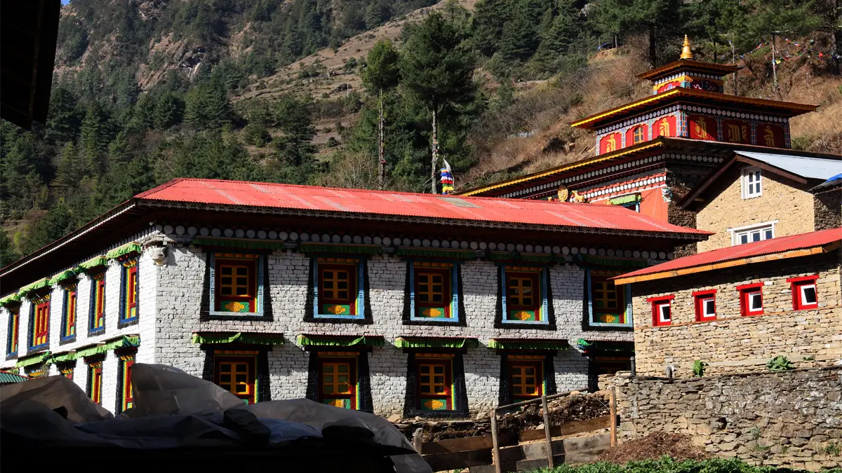 Whitewashed monastery building with colourful windows near Junbesi