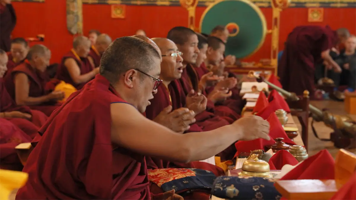 Buddhist monks chanting during a prayer ceremony at a monastery near Junbesi