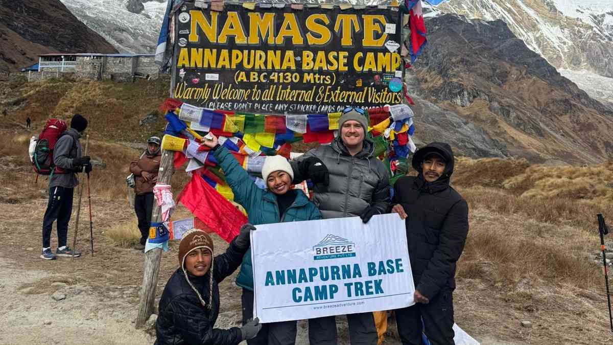 Breeze Adventure team holding company banner in ABC trek