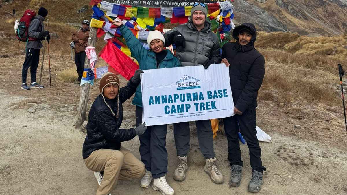 Breeze Adenture team holding company banner in ABC trek