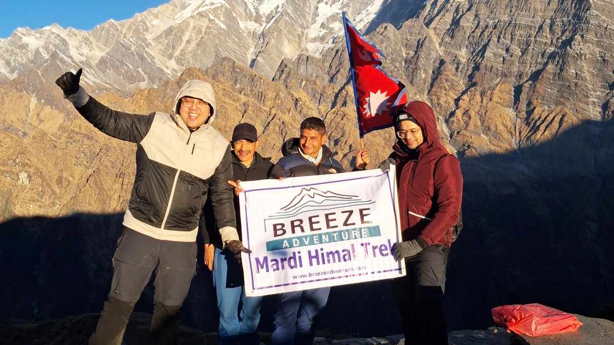 Breeze Adventure team with company banner in Mardi Himal