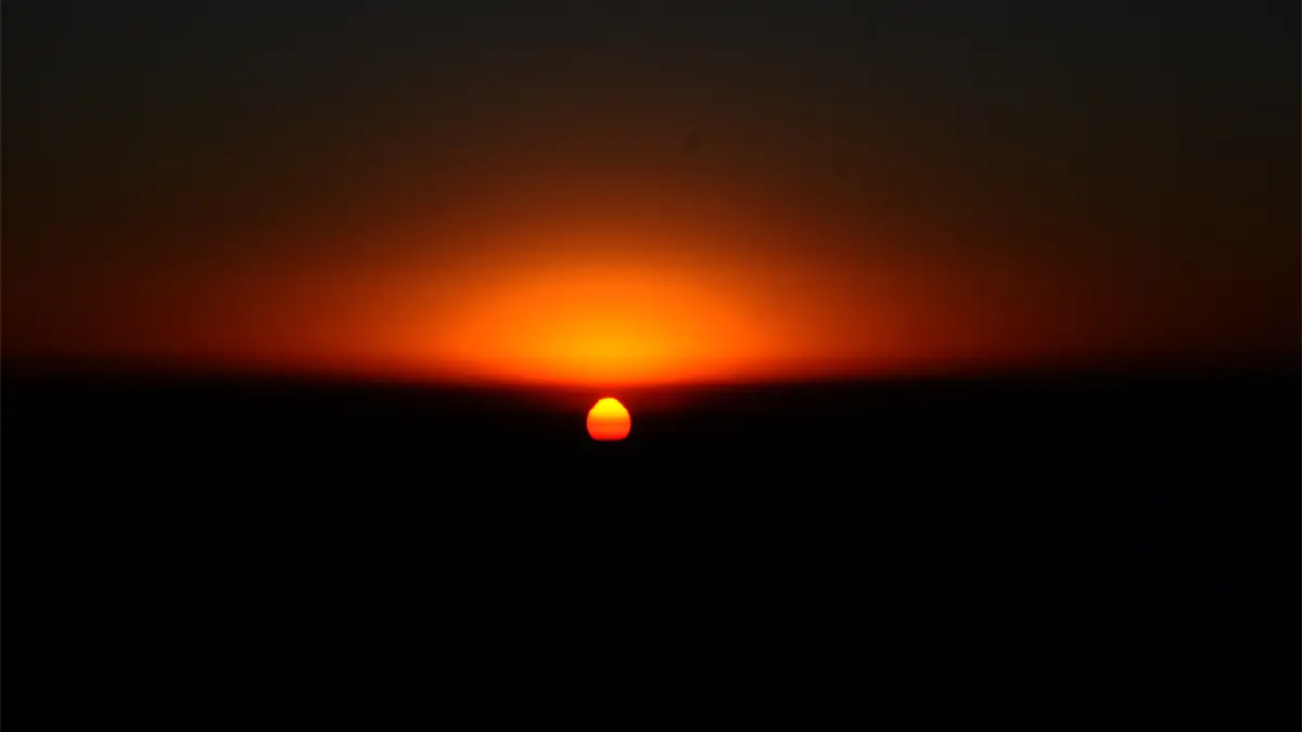 Sunrise glowing on the horizon over the Himalayas in Nepal