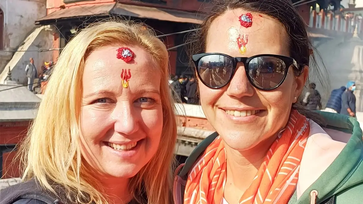 Happy Tourists putting traditional tika