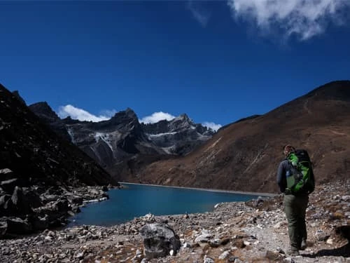 7 Days Gokyo Lakes Trek thumbnail – trekker beside turquoise lake in Everest region Nepal